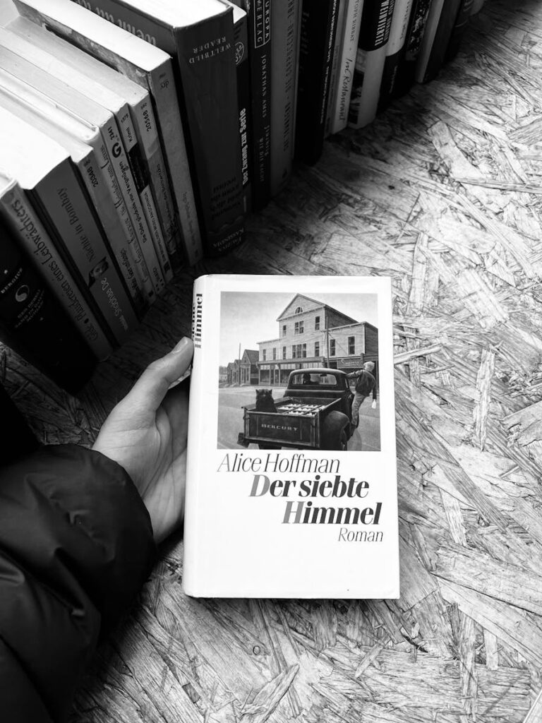 Black and White Photo of a Hand Holding a Book