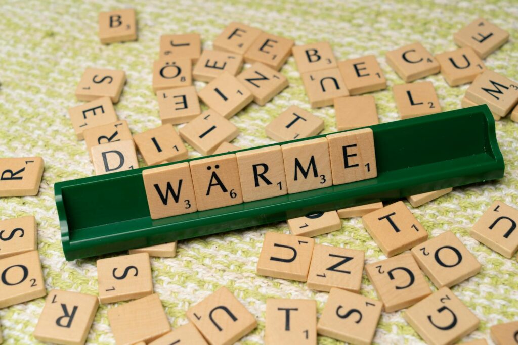 A scrabble board with the word warm on it